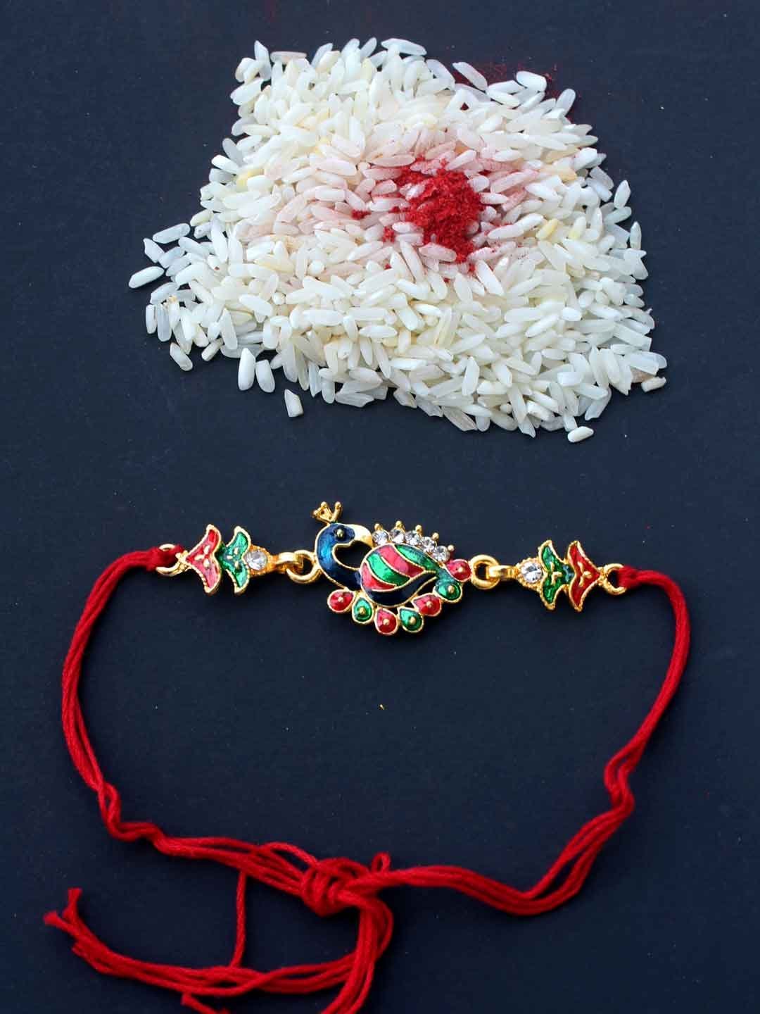 Enamelled-metallic-peacock-rakhi.jpg Enamelled Metallic Peacock Rakhi - Image 1