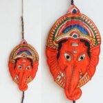 Orange Ganesha-face Tholu Bommalata wall-hanging