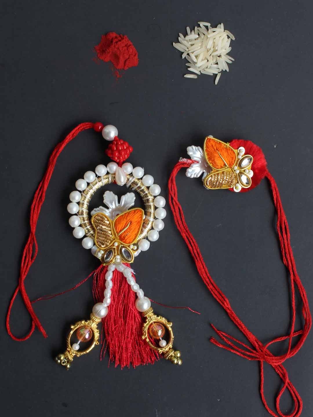 Red-orange-golden-zariwork-Bhaiya-bhabhi-rakhi.jpg Red and orange zari Bhaiya-Bhabhi Rakhi - Image 1
